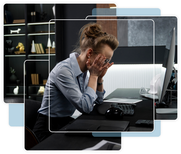 Person sitting at desk with head in hands
