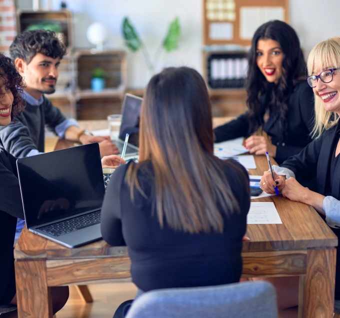 Group of coworkers discussing around a table
